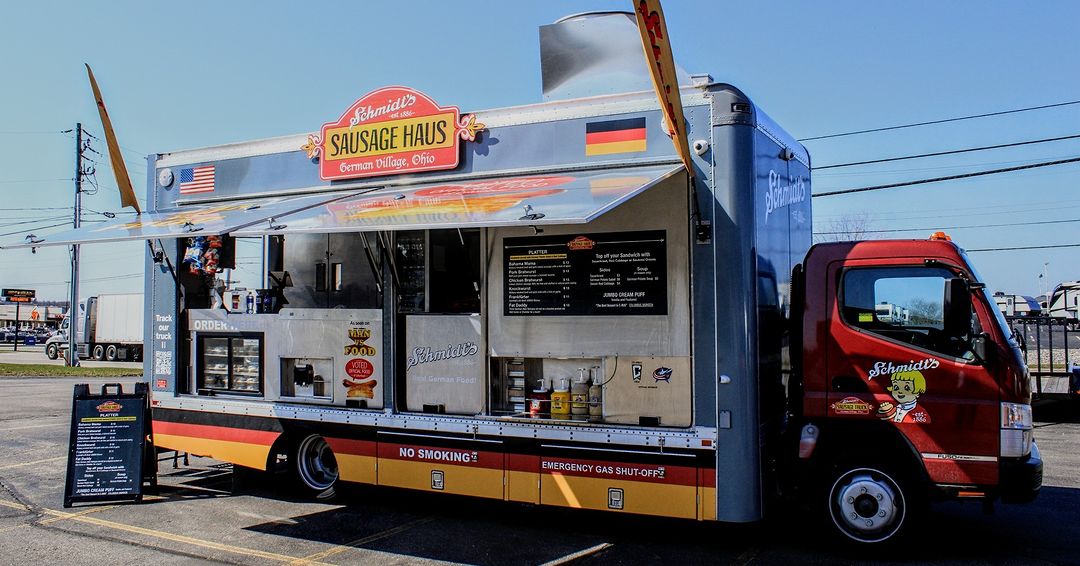 A food truck sits in a parking lot